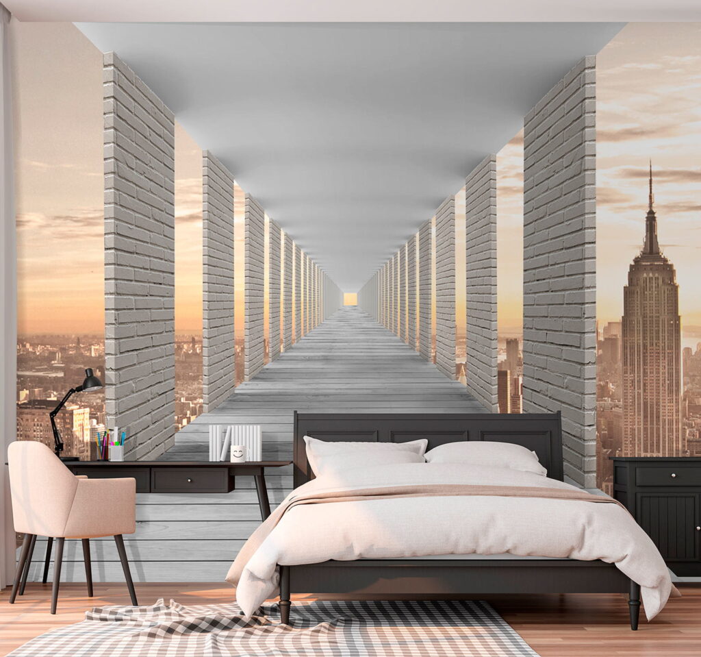 Long walkway with pillars and a city in the background
