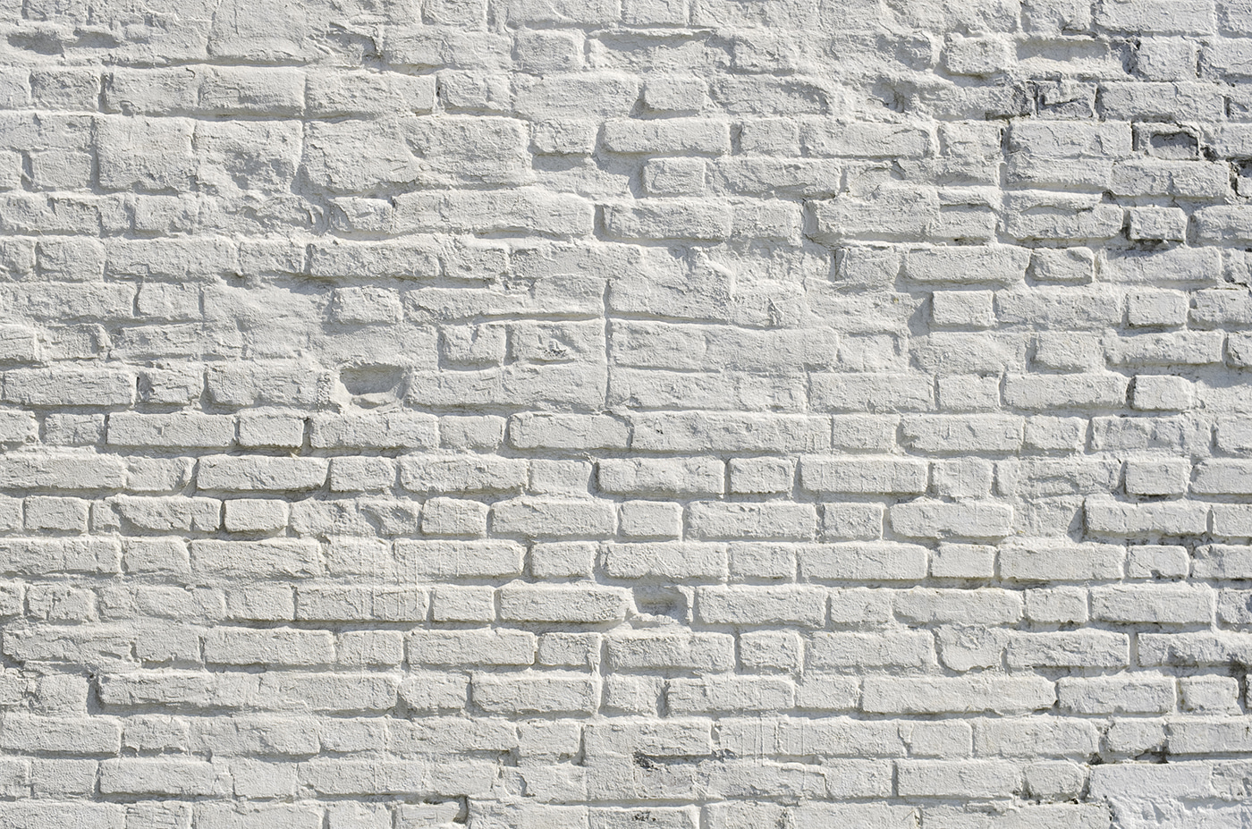 White brick wall with black spots