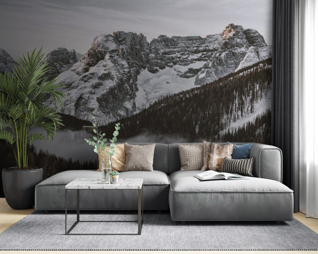 Snowy mountain range with trees and a building