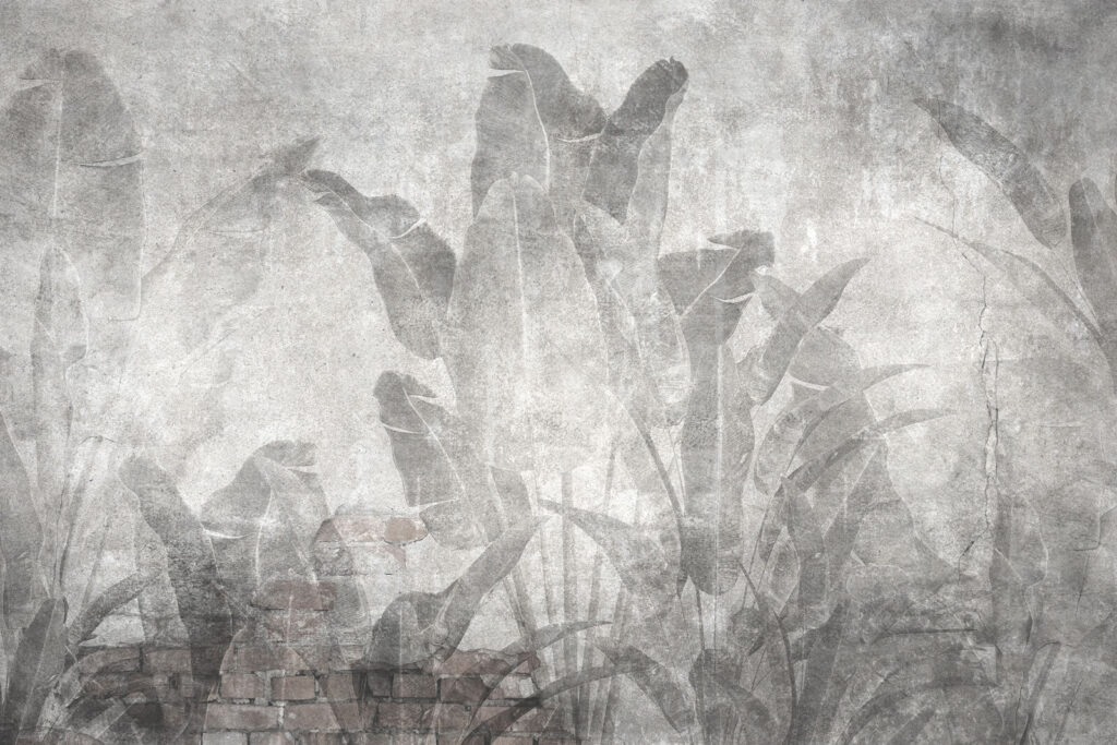 Grey wall with leaves and a brick wall