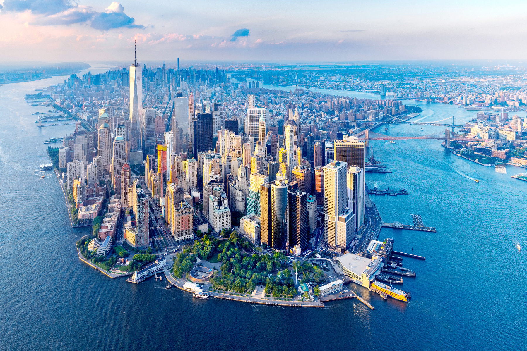 A city with many tall buildings and a body of water A city with many tall buildings and a body of water