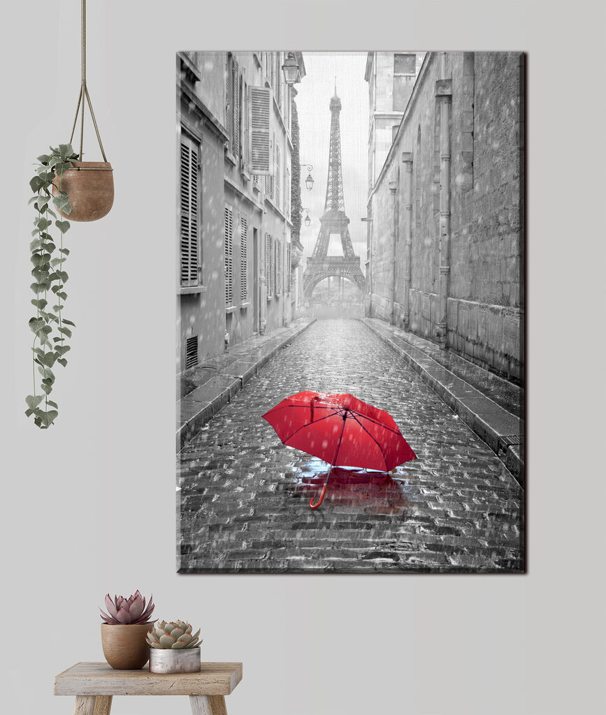 A red umbrella in a street with a tower in the background A red umbrella in a street with a tower in the background