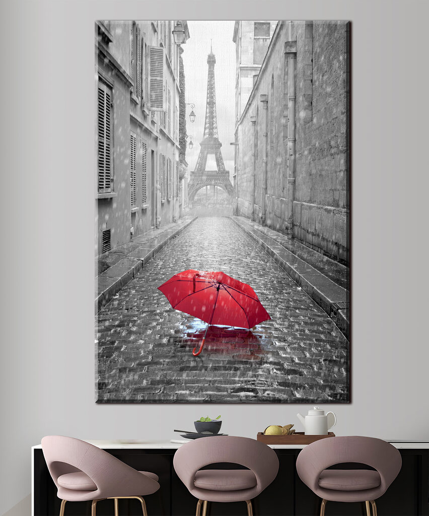 A red umbrella in a street with a tower in the background A red umbrella in a street with a tower in the background