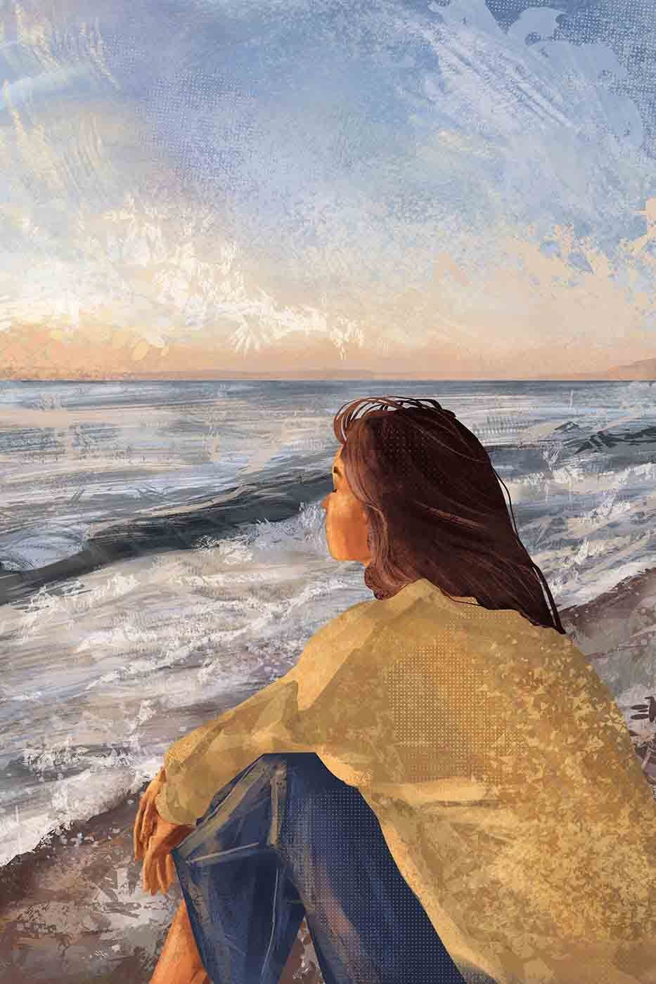 A woman sitting on a beach looking out to the ocean