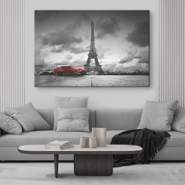 A red car parked in front of a large tower A red car parked in front of a large tower