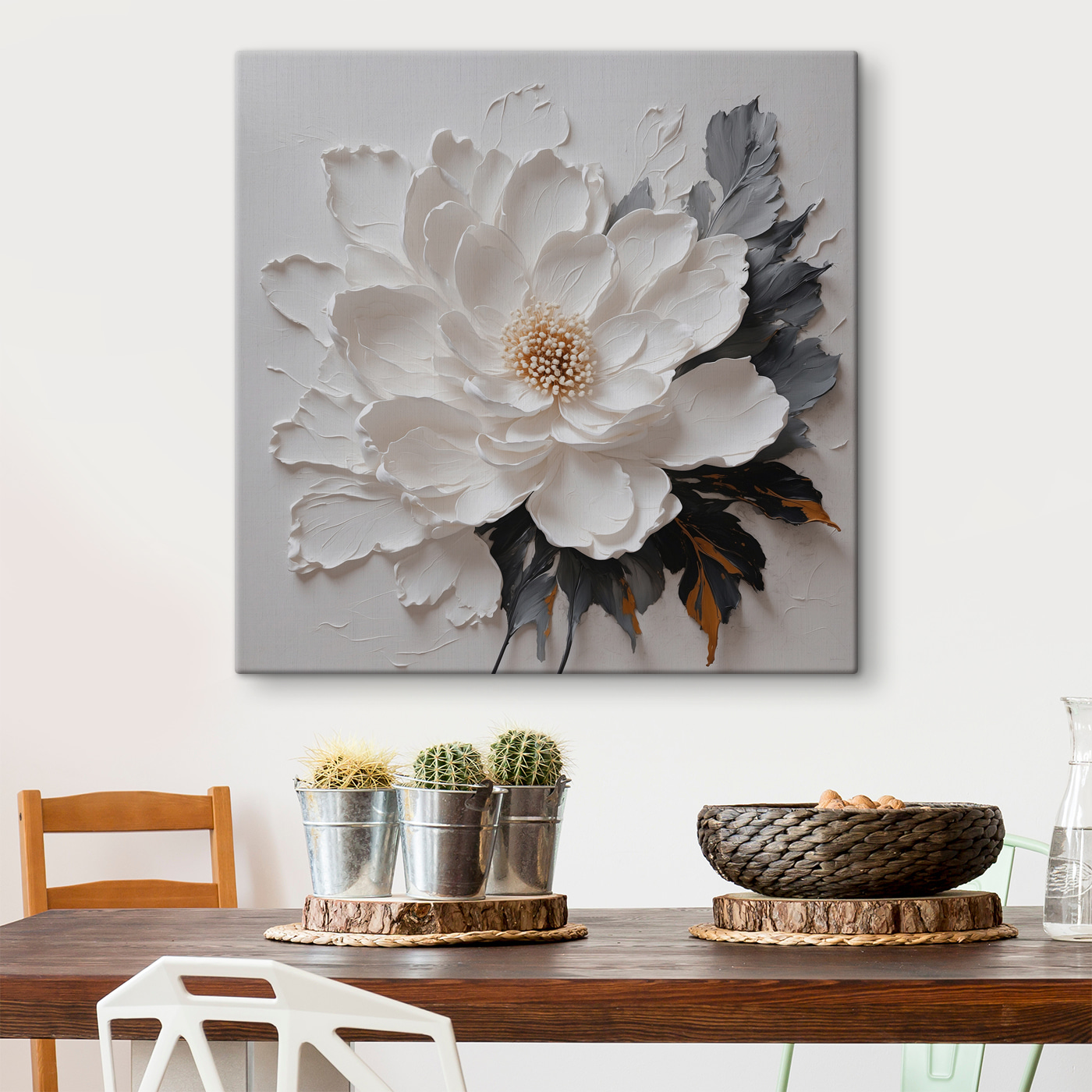 A white flower with black and grey leaves