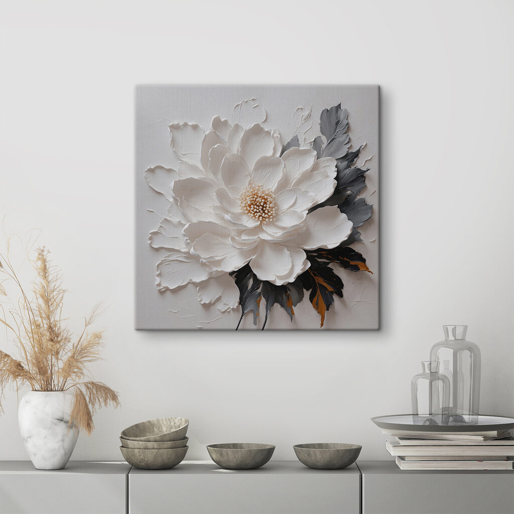 A white flower with black and grey leaves