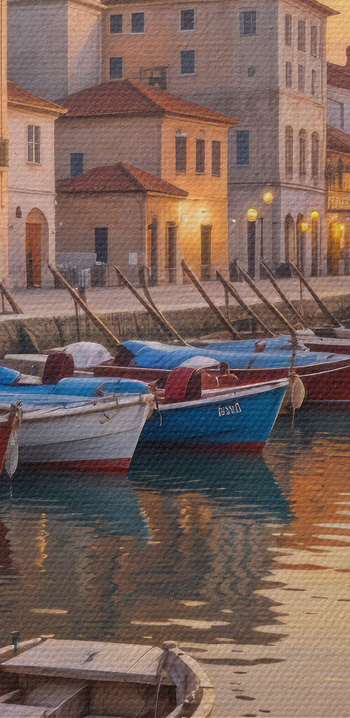 Boats on the water with buildings in the background Boats on the water with buildings in the background