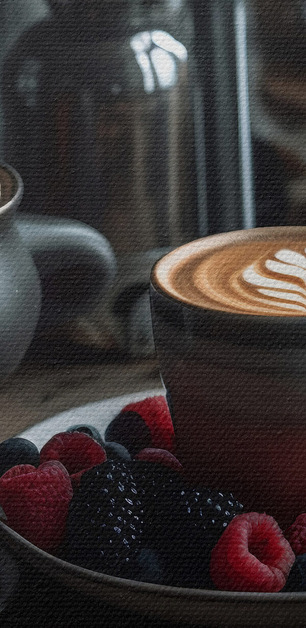 Šálek kávy s latté art na talíři s ovocem a cereáliemi Šálek kávy s latté art na talíři s ovocem a cereáliemi