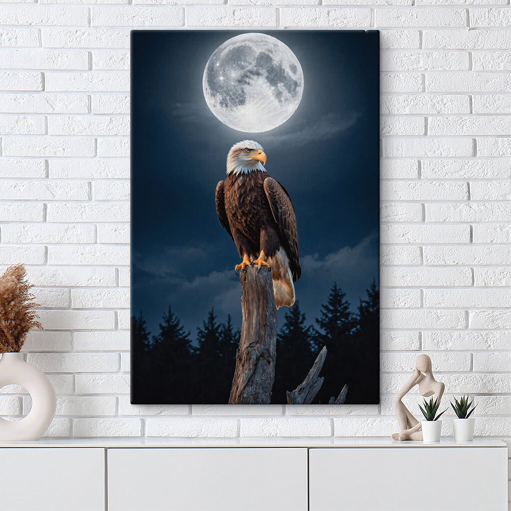 Bald eagle on a post with a full moon in the background