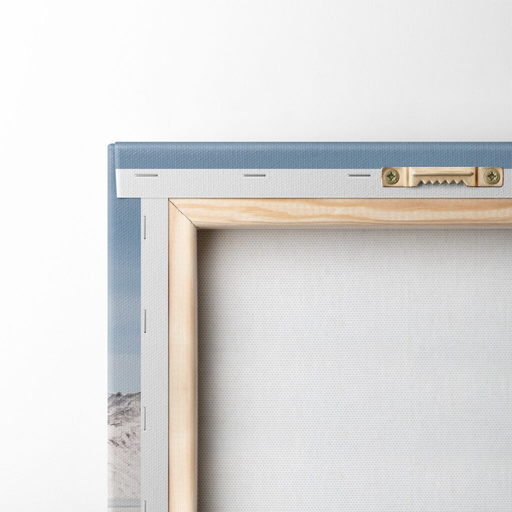 Red house on an island in water with snow covered mountains in the background