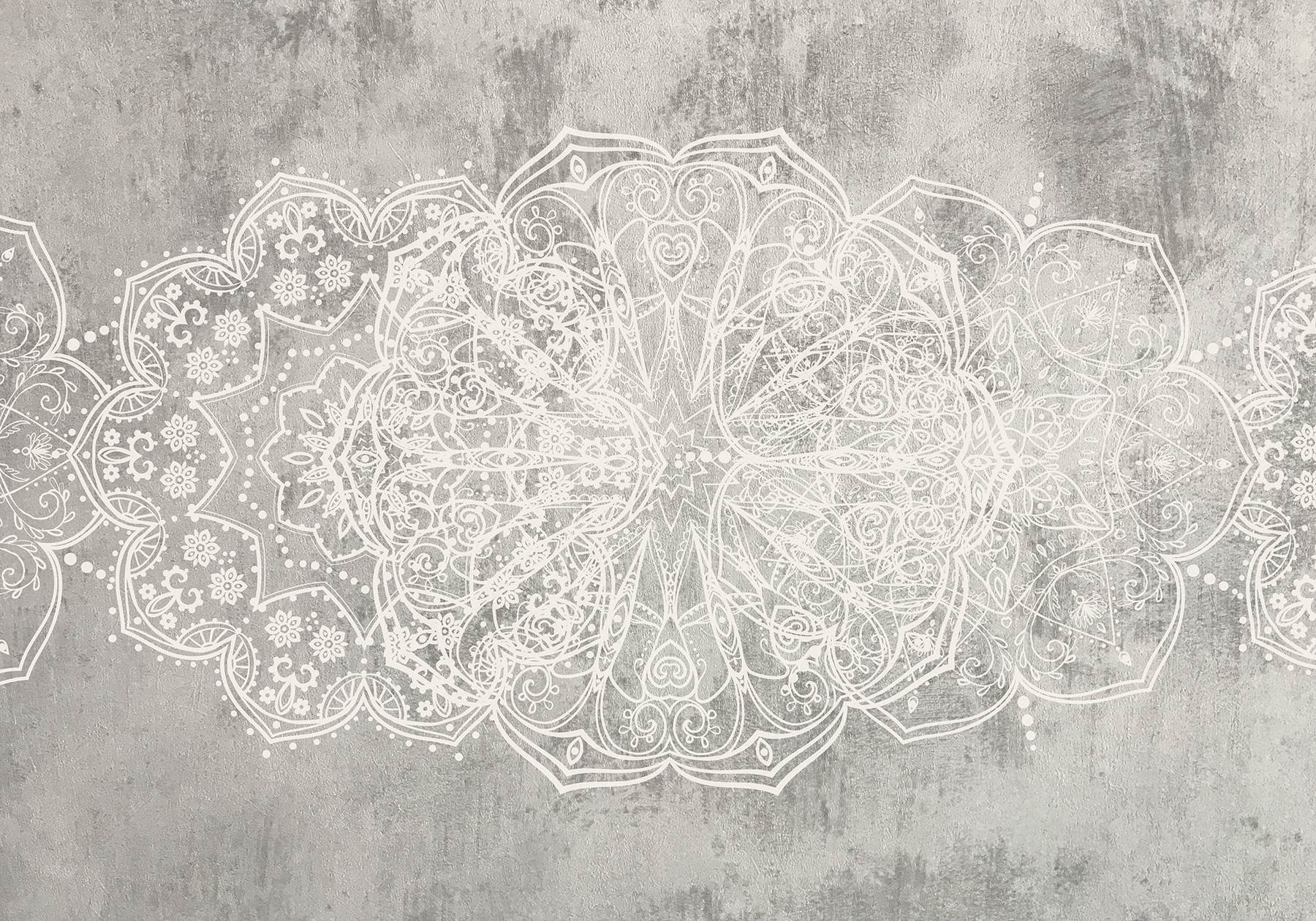 White ornate design on a grey surface
