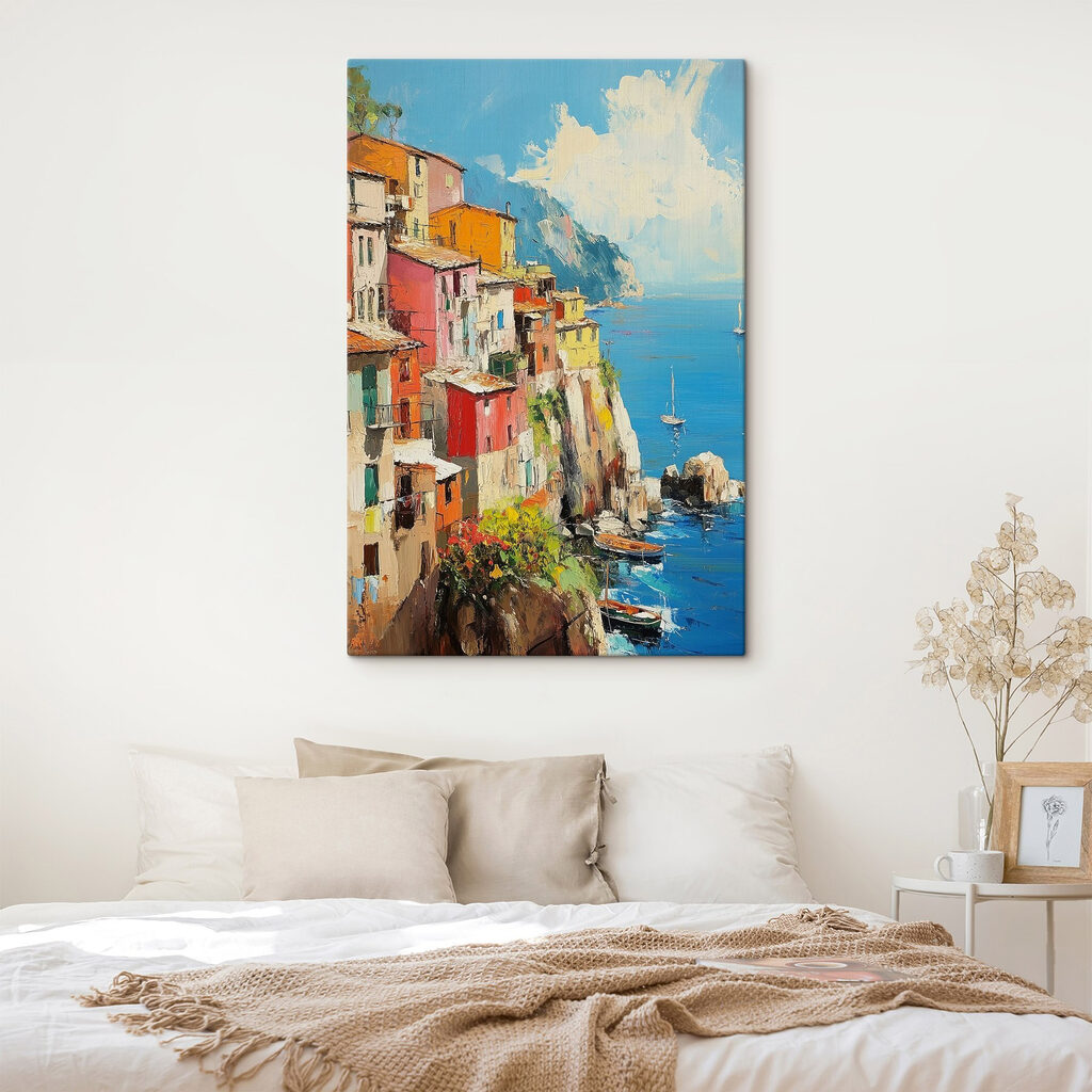 Painting of a colorful town on a cliff by the water