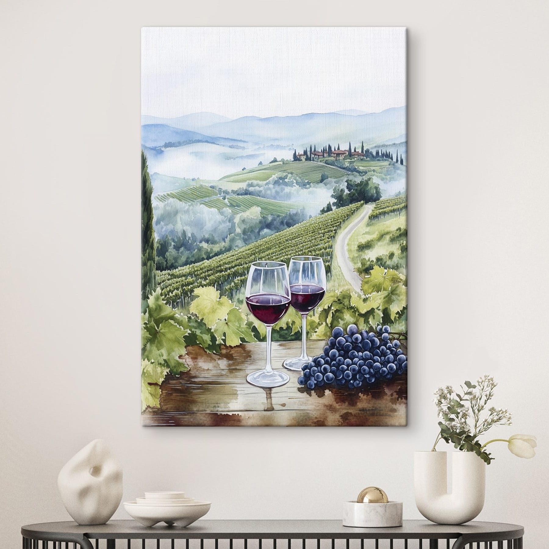 Watercolor of wine glasses on a table with grapes and hills in the background