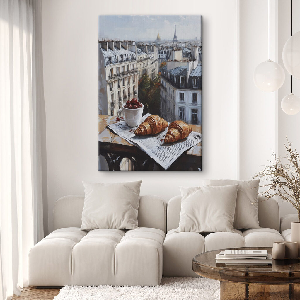 Cup of coffee and croissants on a table with buildings in the background