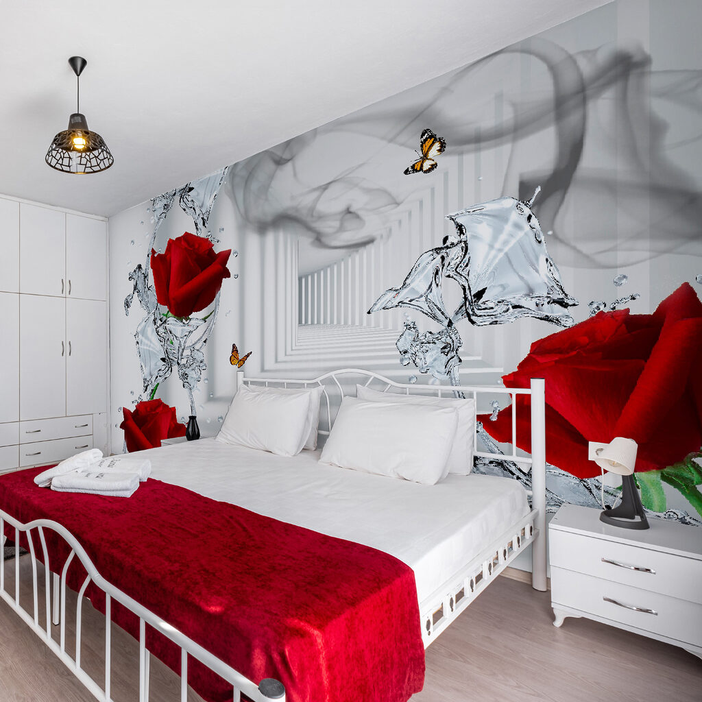 Red roses and butterflies in a glass