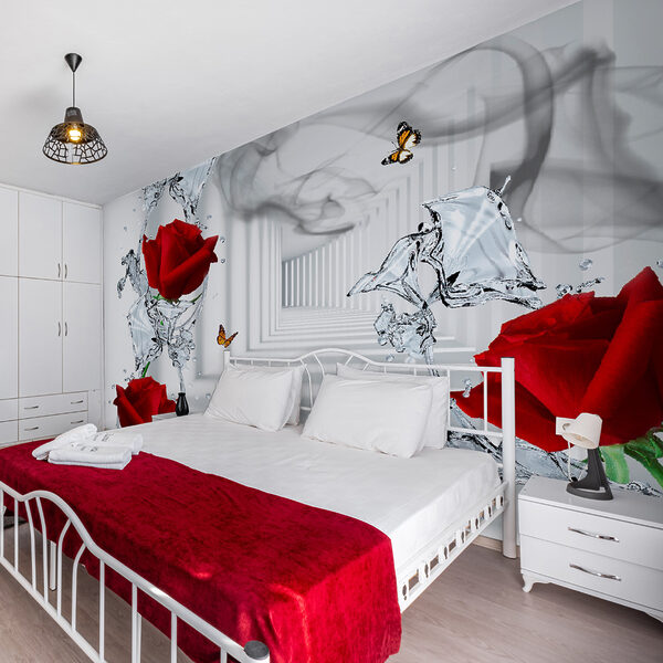 Red roses and butterflies in a glass