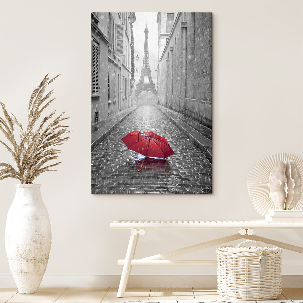 A red umbrella in a street with a tower in the background A red umbrella in a street with a tower in the background