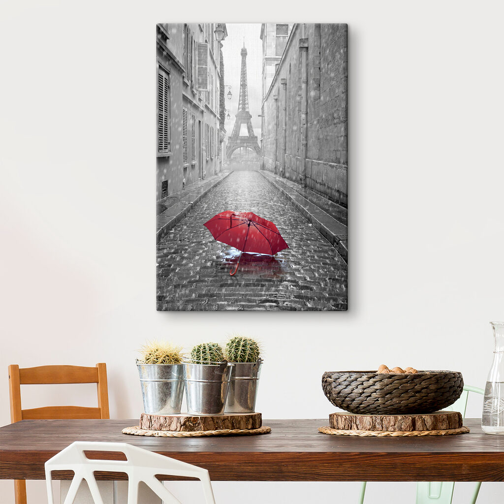 A red umbrella in a street with a tower in the background A red umbrella in a street with a tower in the background