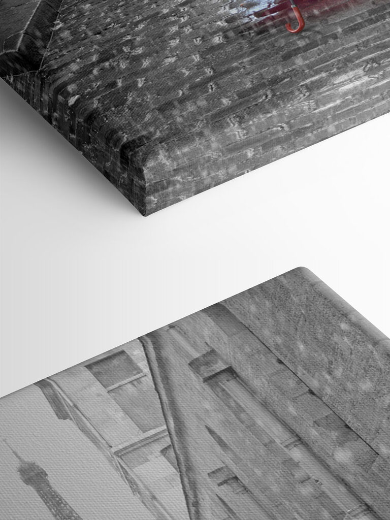 A red umbrella in a street with a tower in the background A red umbrella in a street with a tower in the background