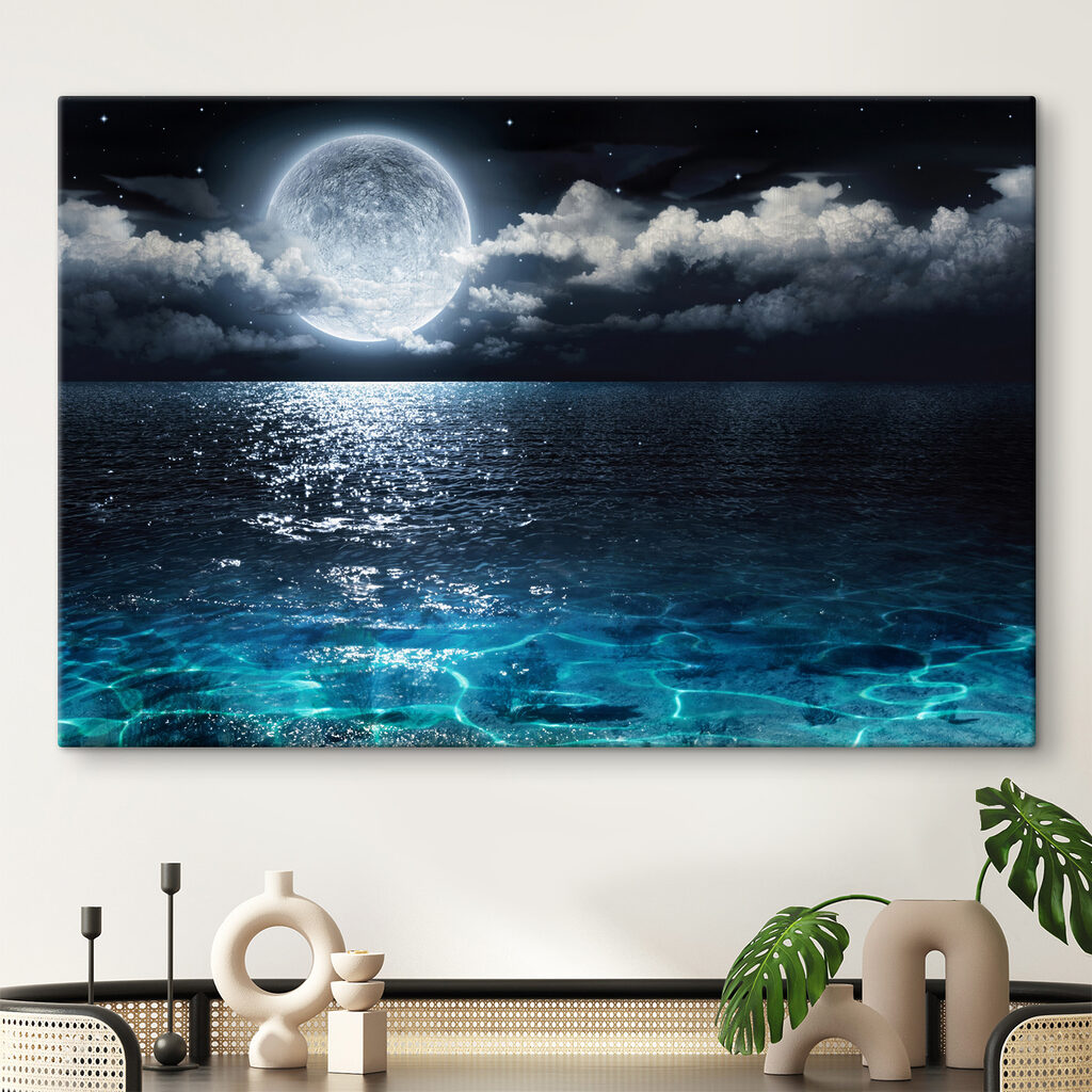 A moon over water at night