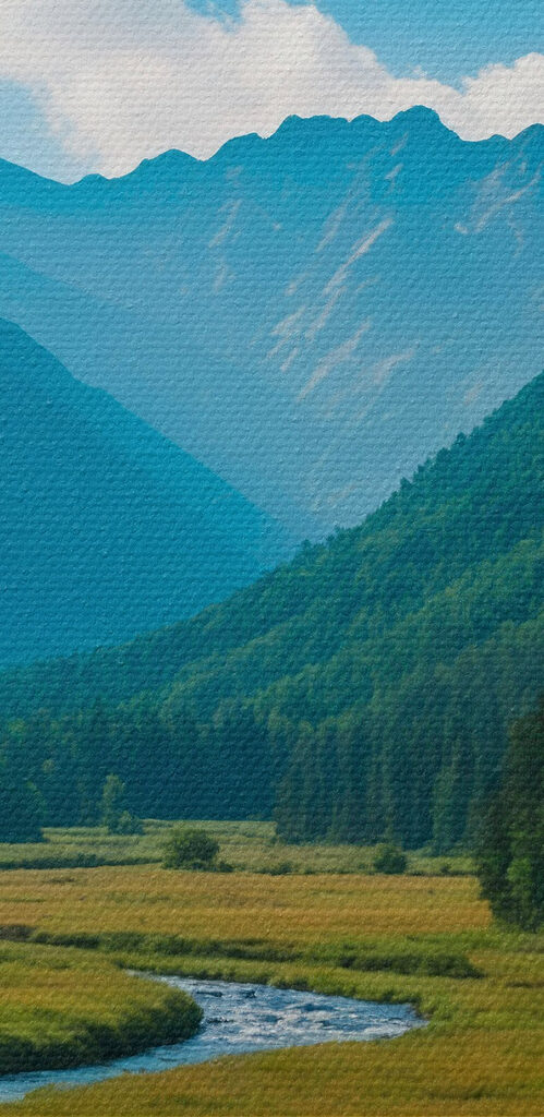 River running through a valley with mountains in the background