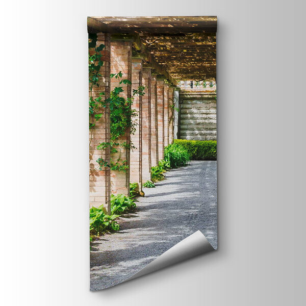 Walkway with stone pillars and vines