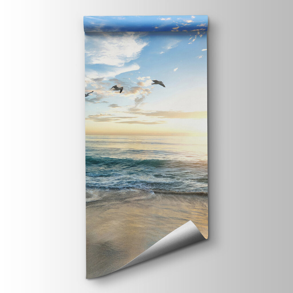 Beach with birds flying over the water