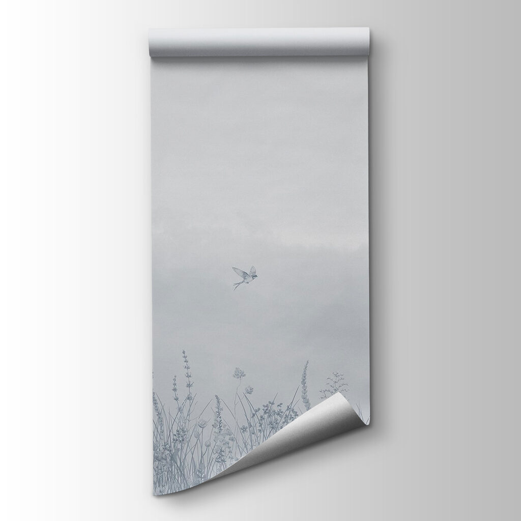 Bird flying over a field of flowers