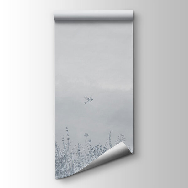 Bird flying over a field of flowers