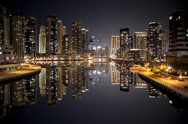 City skyline with lights reflecting on water