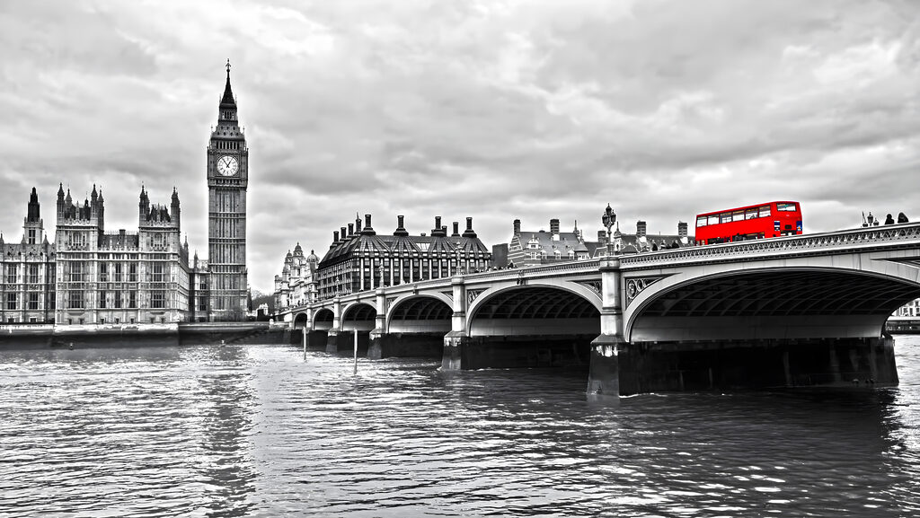 Bridge over water with a clock tower and a red bus Bridge over water with a clock tower and a red bus