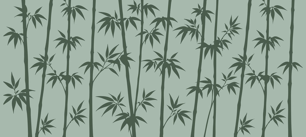Green bamboo leaves on a grey background