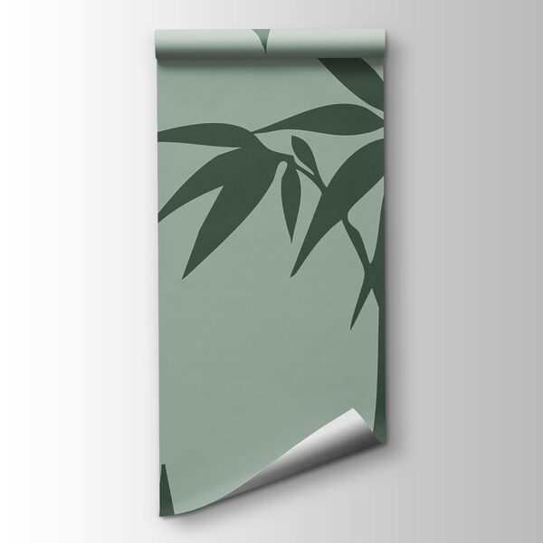 Green bamboo leaves on a grey background