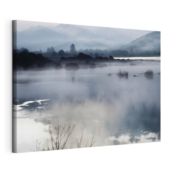 Foggy landscape with mountains and water