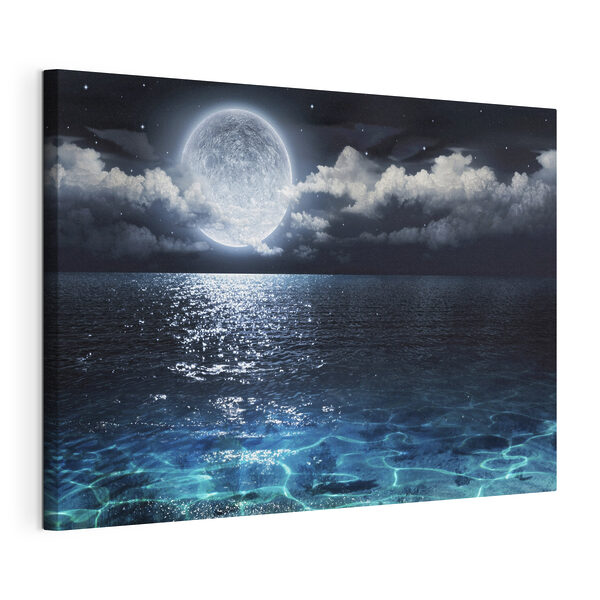A moon over water at night